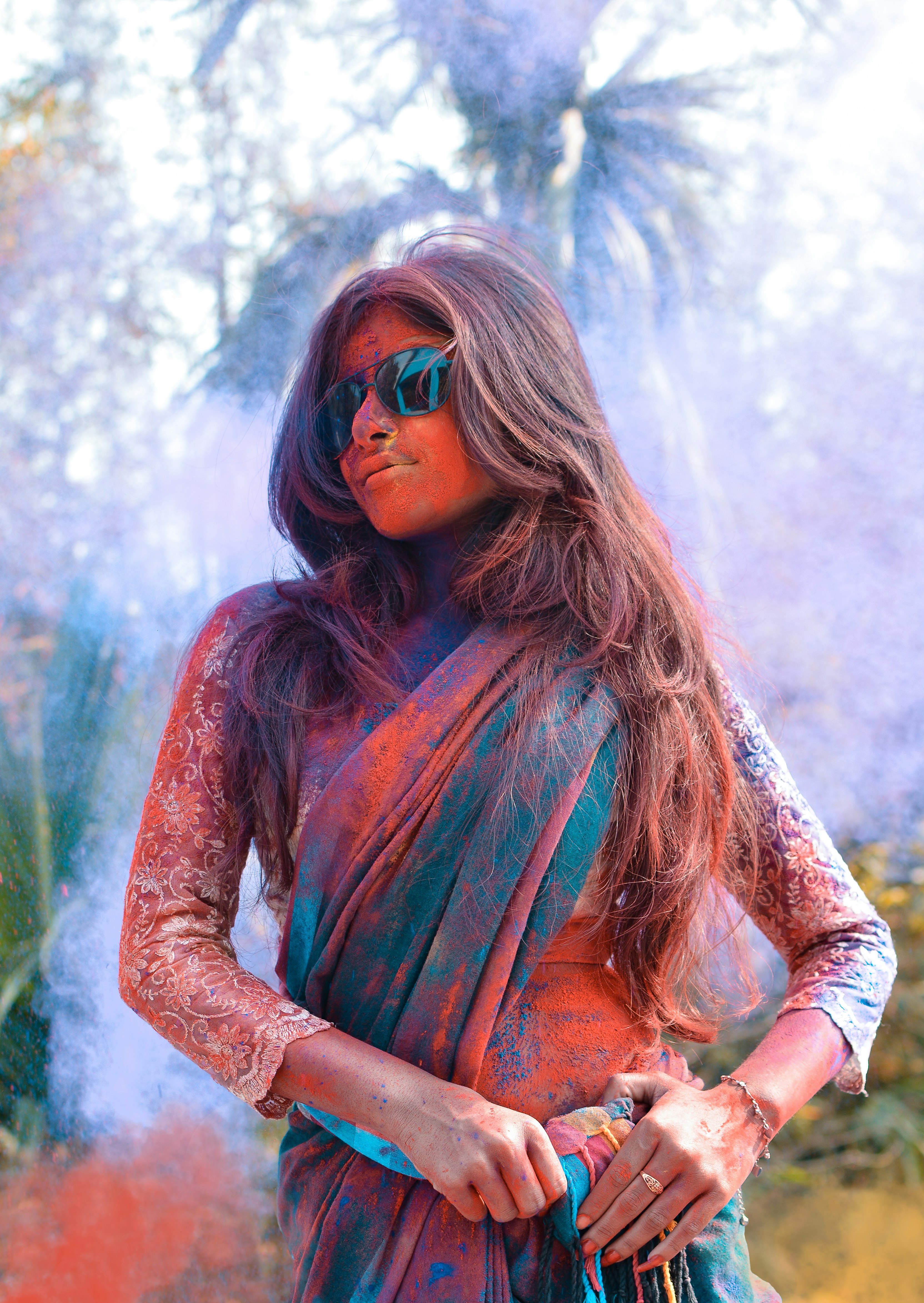 selective focus photo of woman wearing green and brown shawl covered with powder